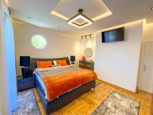 a bedroom with a bed and a tv on the wall at B&B Lovac in Ulcinj