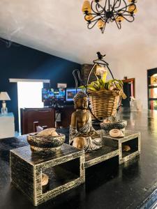 a statue of a buddha sitting on a table at RocaMar Hostel Boutique in Punta del Este +90 photos