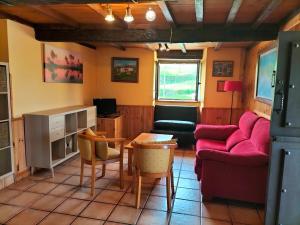 a living room with a couch and a table at Apartamentos La Corona in Parres de Llanes