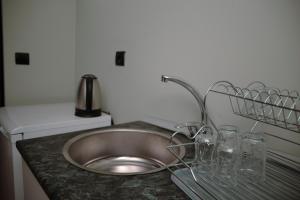 a kitchen sink with glasses on a counter at EvergreenGlamping in Kumluca