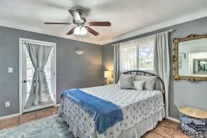 a bedroom with a bed and a ceiling fan at Delightful Family Getaway with Covered Patio! in Tucson