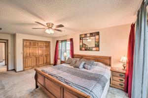 a bedroom with a bed and a ceiling fan at Kayaks and Boat Dock Waterfront Home in Grove in Grove