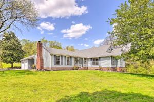 a house with a lawn in front of it at Chic Nashville-Area Retreat with Private Pool! in Kingston Springs