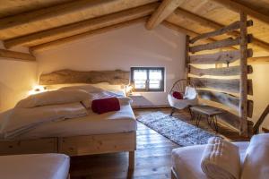a bedroom with two beds in a room with wooden ceilings at Casa Vacanza Ca' de l'elmo in Castello dellʼAcqua