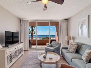 a living room with a couch and a tv at The Beach Club Doral 306 - Spacious Beachfront Condo! in Gulf Shores