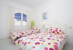 a bedroom with two beds with polka dot sheets at Villa de Carrida in Puerto del Carmen