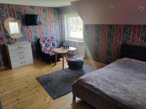 a bedroom with a bed and a table and a chair at Stay at Svaja in Plungė