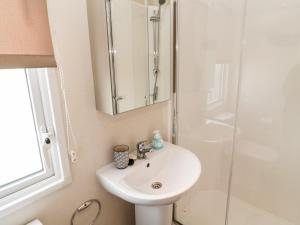 a bathroom with a sink and a shower at Moonlight Lodge in Morpeth