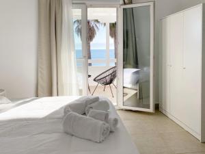 a bedroom with a bed with a towel on it at Palm Suite Green in Porto Heli