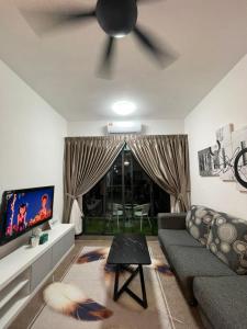a living room with a couch and a ceiling fan at D’Impiana Homestay @Vista Bangi in Kajang