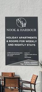 a sign that is on a wooden table at Nook and Harbour Holiday Apartments & rooms in Weston-super-Mare