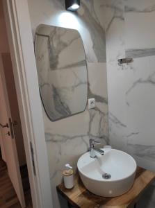 a bathroom with a white sink and a mirror at Casa al Tagas in Kruševo