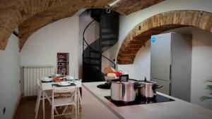 a kitchen with two pots on a stove with a table at Sant'Angelo House in Citta' Sant'Angelo