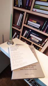 a book sitting on a table next to a book shelf at Sant'Angelo House in Citta' Sant'Angelo