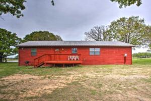 a red barn with a porch in a field at Emory Escape with Pond Access Less Than 13 Mi to Lake! in Emory