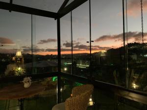 a balcony with a view of a city at night at Casablanca Hotel Boutique in Campos do Jordão +232 photos