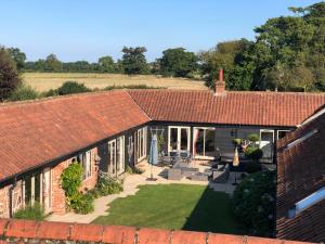 an aerial view of a house with a yard at WOW Lodge Farm Broads Barn sleeps 12 Hot tub Private Courtyard Special family celebrations Elegant dining Close to Norwich Great for Team Building in South Walsham