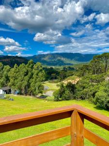 een uitzicht vanaf het terras van een huis met uitzicht op een veld bij Tiny House Urubici in Urubici