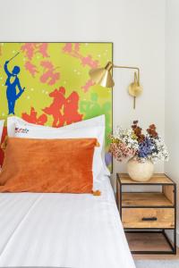 a bedroom with a bed with a colorful wall at Bairro Alto Music Guest House in Lisbon