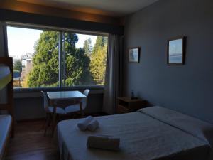 a bedroom with a bed and a large window at Center Vistas in San Carlos de Bariloche