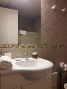 a bathroom with a white sink and a mirror at Center Vistas in San Carlos de Bariloche +132 photos