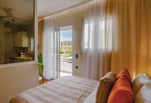 a bedroom with a bed and a view of a kitchen at Eftihia Studios in Palaiochora