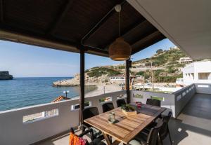 a table on the balcony of a boat at Beach front apartment with swimming pool in Ligaria