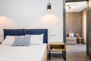a bedroom with a large bed with a blue headboard at Linden Apartments in Potos