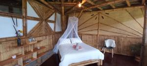Postel nebo postele na pokoji v ubytování Ecohotel Soplo del Tambo