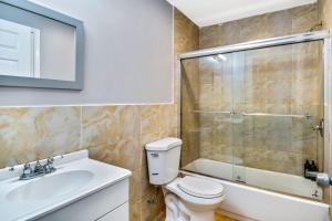 a bathroom with a toilet and a sink and a shower at The Vacation spot! 2bd apartment steps away from the convention center in Philadelphia