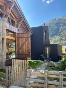 a house with a wooden fence in front of it at Stadlnest Moser in Neustift im Stubaital