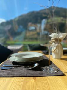 a plate and a wine glass on a table at Stadlnest Moser in Neustift im Stubaital