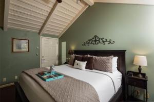 a bedroom with a large bed with a tray on it at Inn Above Oak Creek Sedona in Sedona