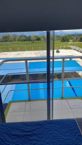a view of a swimming pool from inside a building at VACACIONES a 3 km del Parque del Cafe in Montenegro