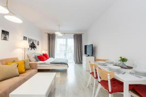 a living room with a couch and a table at Luxury in City -3- Studio Bright & Secure Free Parking in Łódź