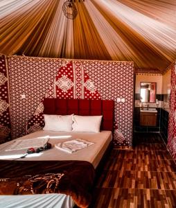 a bedroom with a large bed in a tent at sand magic camp in Wadi Rum