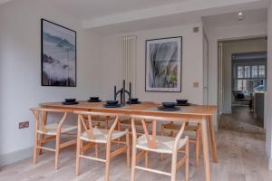 a dining room with a wooden table and chairs at Andrean House, St Andrews in St. Andrews +26 photos