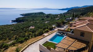 a house with a view of the water at Mani Theasis in Stoupa