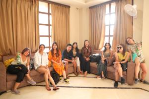 a group of people sitting on a couch at The Taj Vista - Agra in Agra
