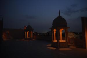 un cenador con luces encendidas por la noche en The Taj Vista - Agra en Agra