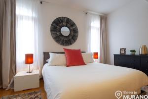 a bedroom with a large bed with a mirror on the wall at MURANO Place - RIVA House in Murano