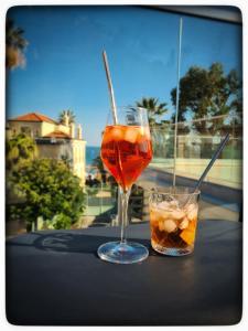 two drinks sitting on a table with a view of the ocean at Le Vallaya Suites & Spa in Menton