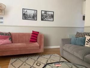 a living room with a pink couch and a rug at Harbour quay in Wick