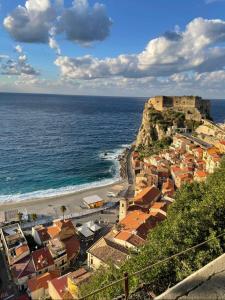 a view of a town with a castle and the ocean at Il Bocciolo - Locazione turistica in Scilla