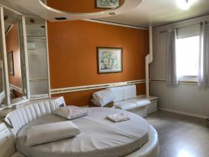 a bedroom with a white bed and a window at Hotel Vip's in Cruz Alta