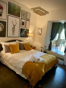 a bedroom with a large bed with yellow pillows at Santafe' in Vietri
