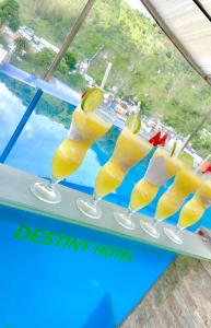 a glass of lemonade on a table next to a window at Destiny Hotel in Baños