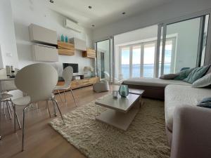 a living room with a couch and a table at First row to the sea - Nautilus Deluxe Apartment in Opatija