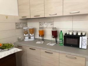 a kitchen with a counter with a microwave and some food at La Mimosa in Pula +35 photos