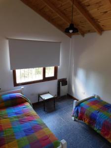 A bed or beds in a room at CABAÑAS LOS COIRONES